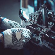 The auto mechanic deconstructs the internal combustion engine for diagnosis and repair. Closeup.